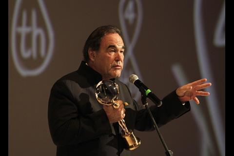 Oliver Stone with his Crystal Globe